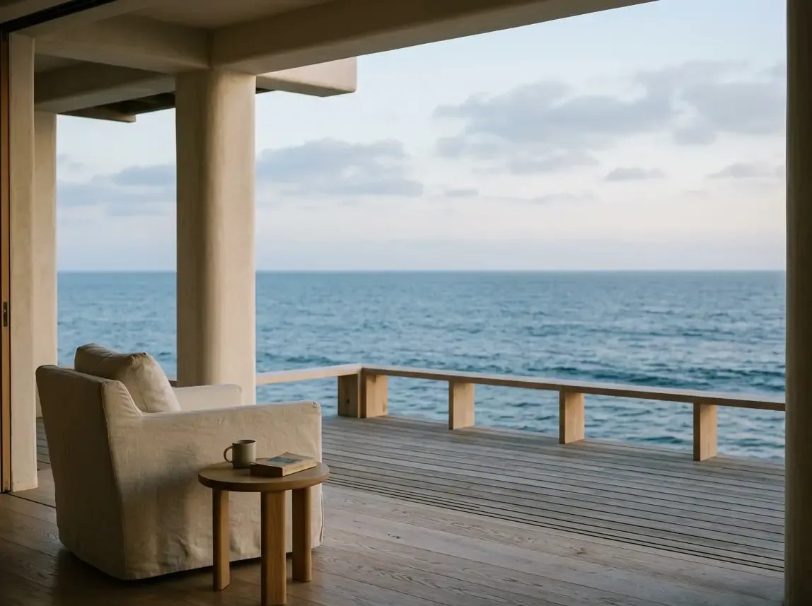 A quiet chair on an oceanfront deck at dusk